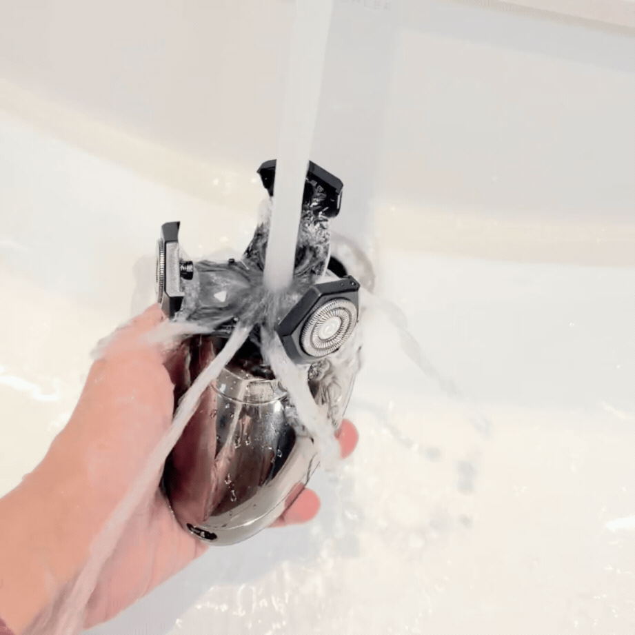 VAVAME women’s electric facial shaver being rinsed fully under running water for easy cleaning